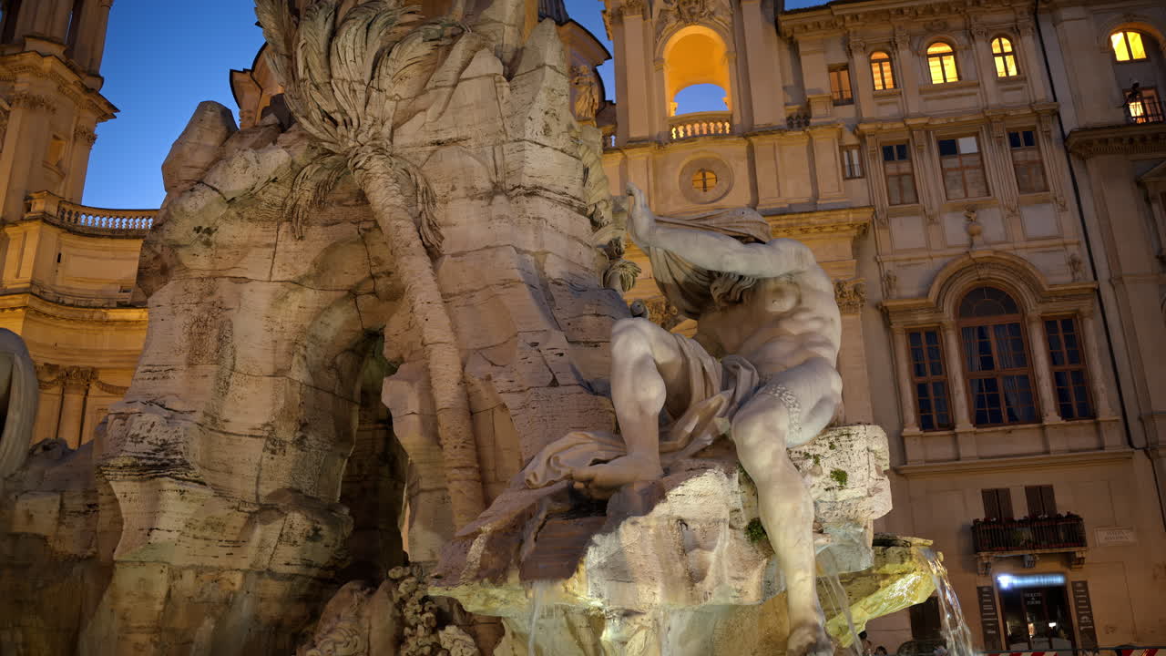 Fountain of the Four Rivers located in Navona square. Rome city square at sunset. Italy