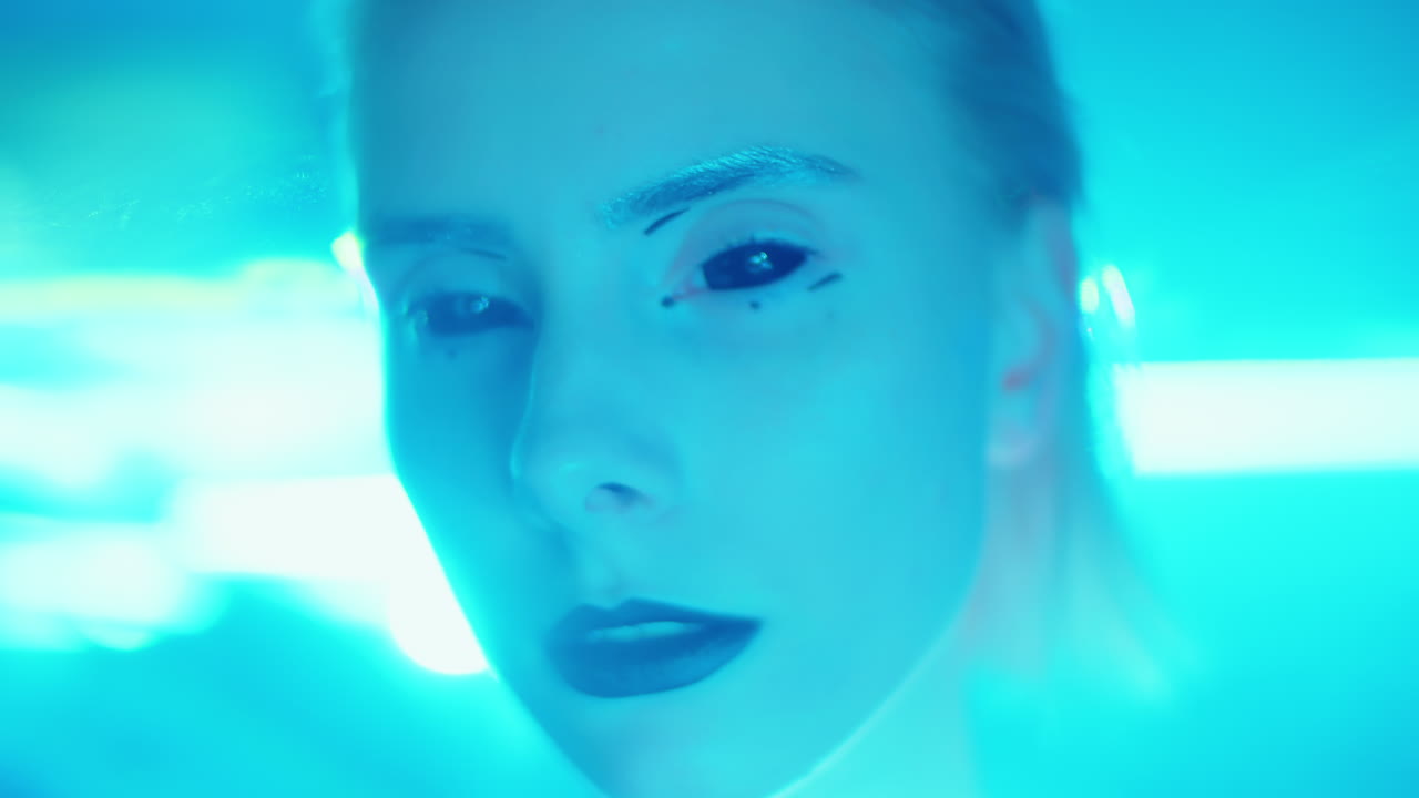 Portrait of Woman with Alien Makeup in Laser Light