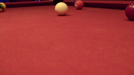 billiard shot with a lot of backspin on red carpet