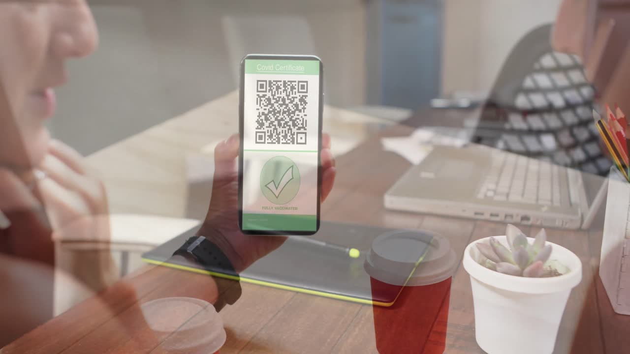 Animation of woman holding smartphone with covid 19 vaccination passport over office