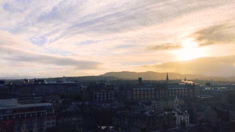 a high up view of edinburgh from the castle at golden hour