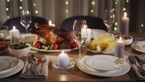 thanksgiving holiday table with turkey in the center of the table
