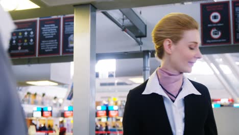 businessman showing his boarding pass at the check-in counter