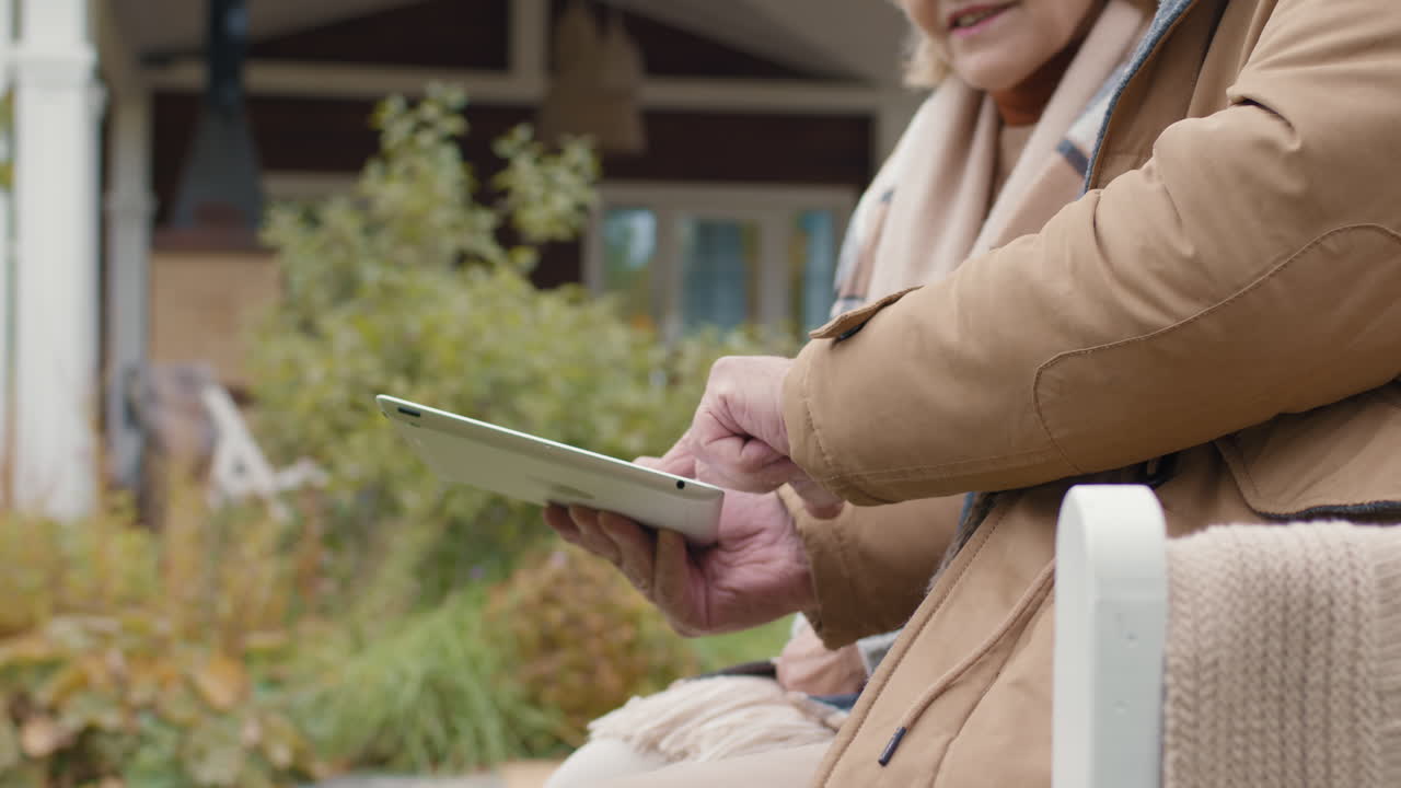 Elderly couple using a tablet outdoors
