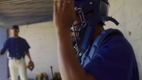 baseball player putting on his equipment
