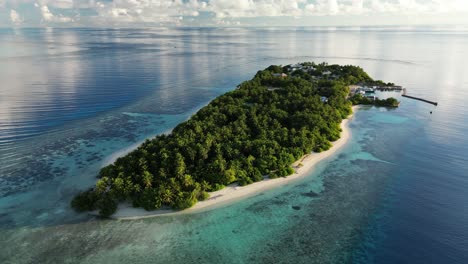 Aerial-drone-video-panning-around-the-small-local-island-of-Thinadhoo-at-sunrise-in-the-Maldives