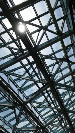 modern glass and metal ceiling structure with sunlight