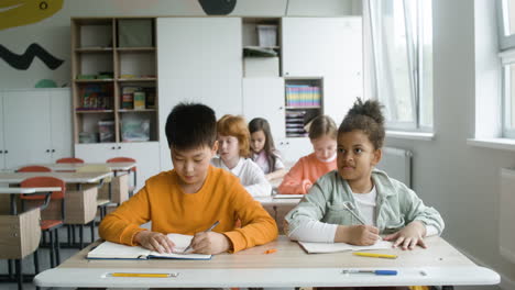 students sitting at the classroom.