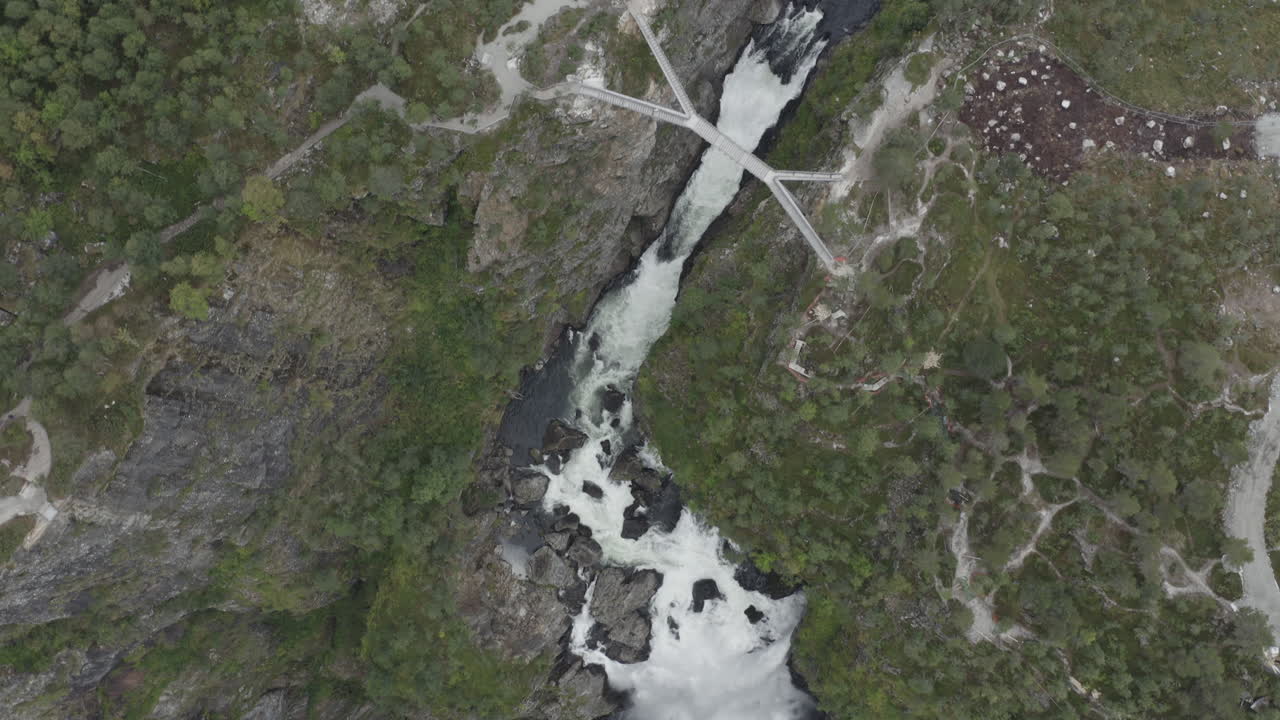 Aerial view of a waterfall cascading down a rocky mountain in Norway