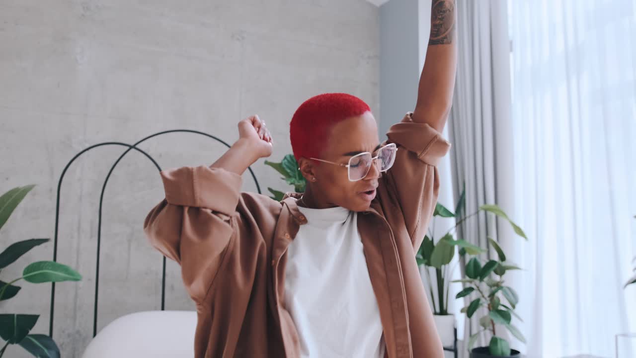 Young energetic african american woman dances listening to favorite music