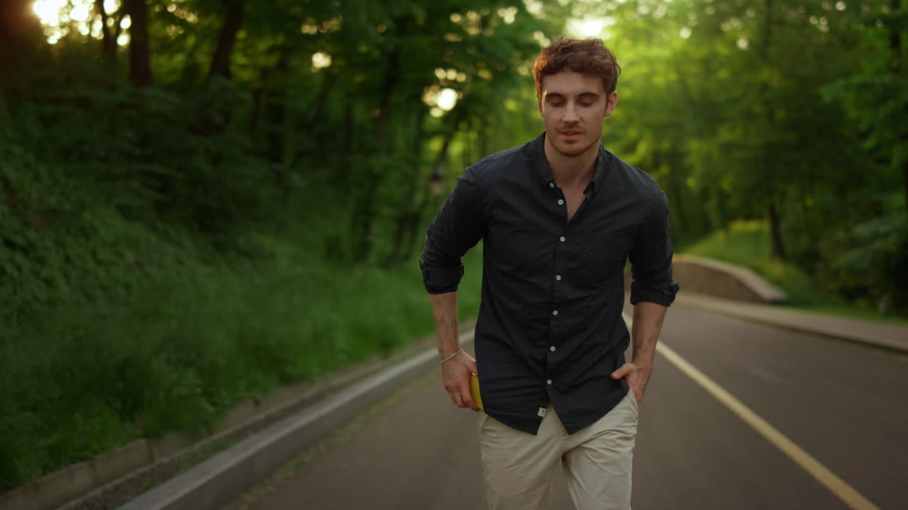 Relaxed man walking outdoors