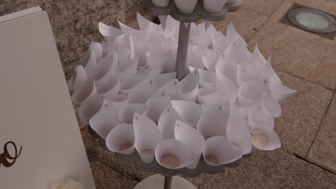paper cones filled with rice set up for wedding ceremony exit