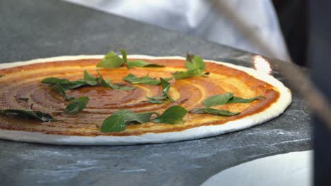 Chef-Preparing-Pizza-with-Basil-and-Mozzarella-Cheese