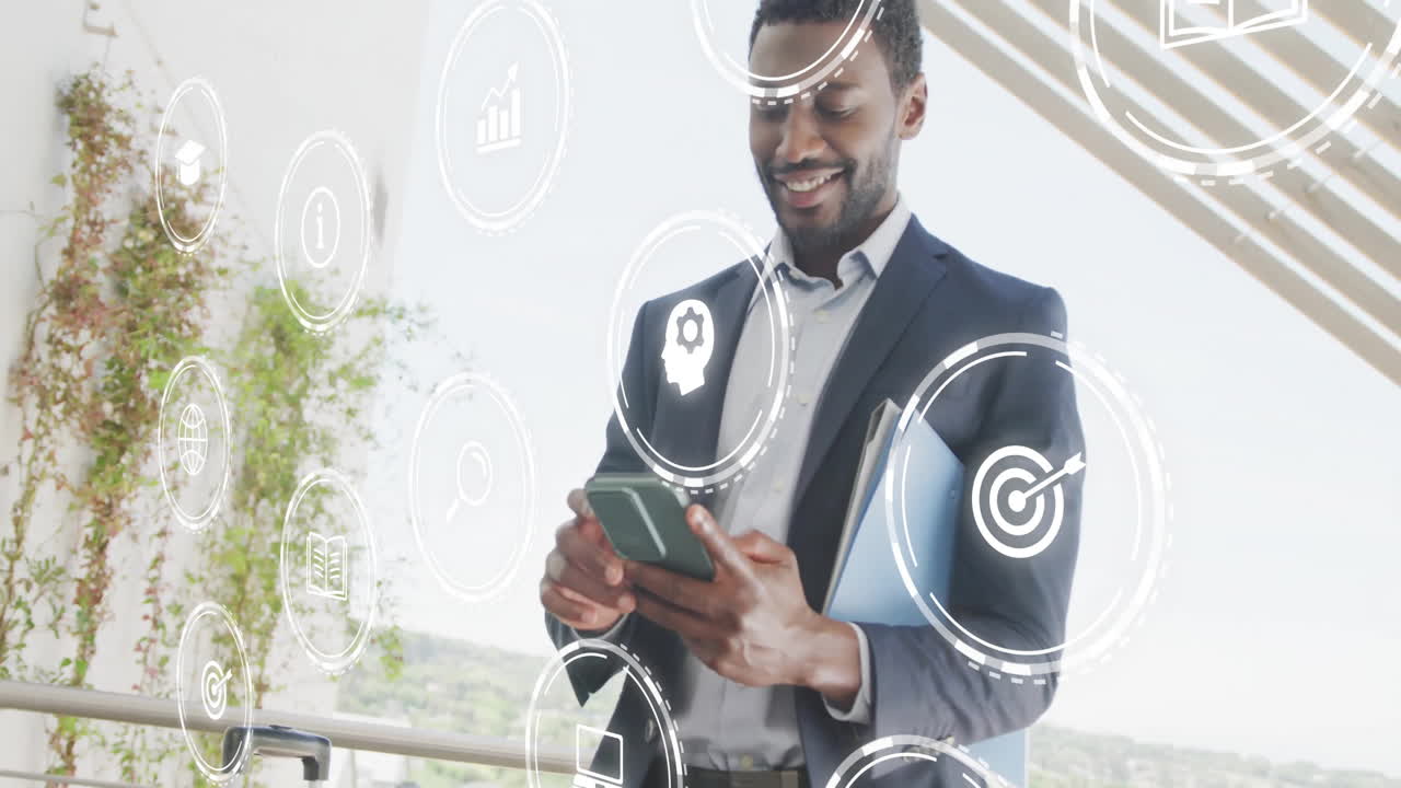 Animation of media icons over african american businessman using smartphone