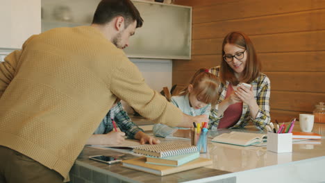 family doing homework together in the kitchen