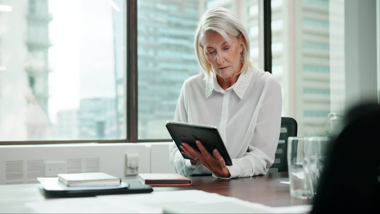 Senior businesswoman using a tablet in an office