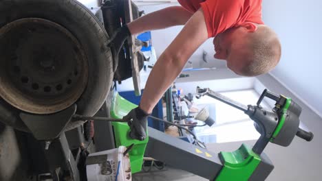 mechanic performing tire service in a workshop