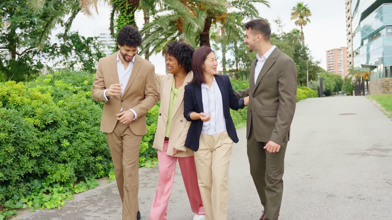 Group of people in suits walking and laughing