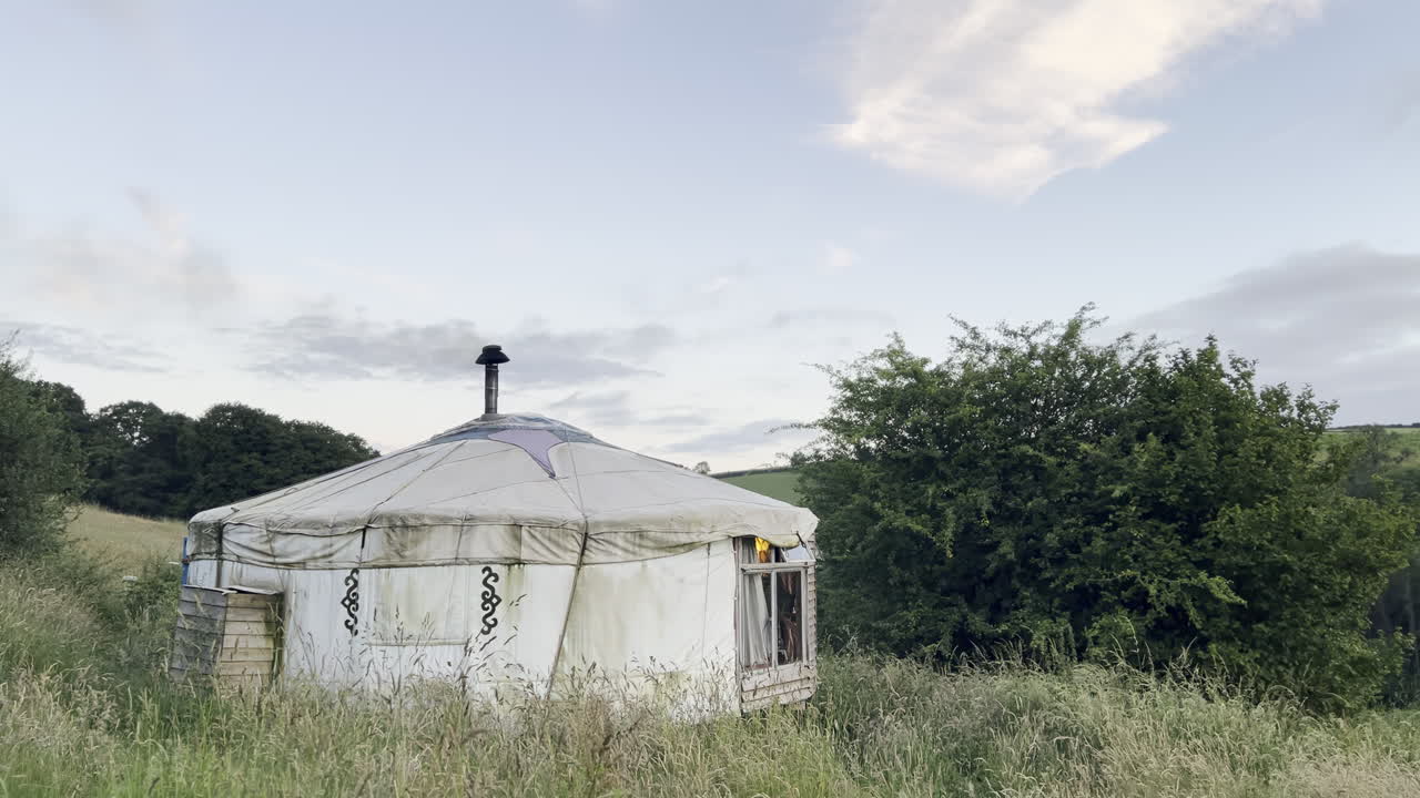 Yurt camping in the countryside of England rolling hills smoke from the chimney