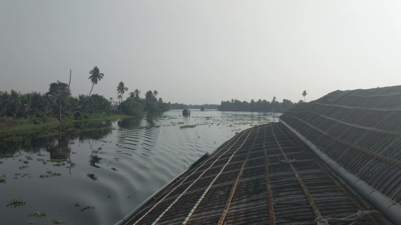 Wide Shot of Traditional Houseboat Moving Downstream at Alappuzha, Kerala, India