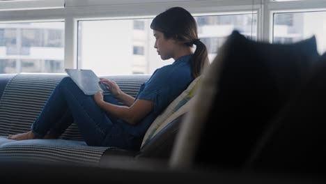 woman choosing movie for streaming on tablet