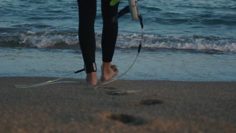 surfer man walking to the beach at sunset preparing for surfing training and search for waves in barcelona, spain, water, ocean exercise in sea with board, athletic male holiday or travel in vacation