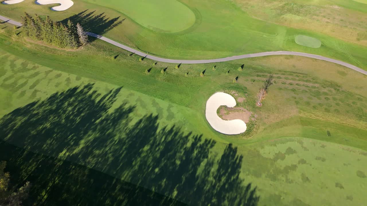 Aerial top down over the lush, mowed, and well-trimmed golf fields of TPC Toronto Osprey Valley in Alton, Caledon, Ontario, Canada