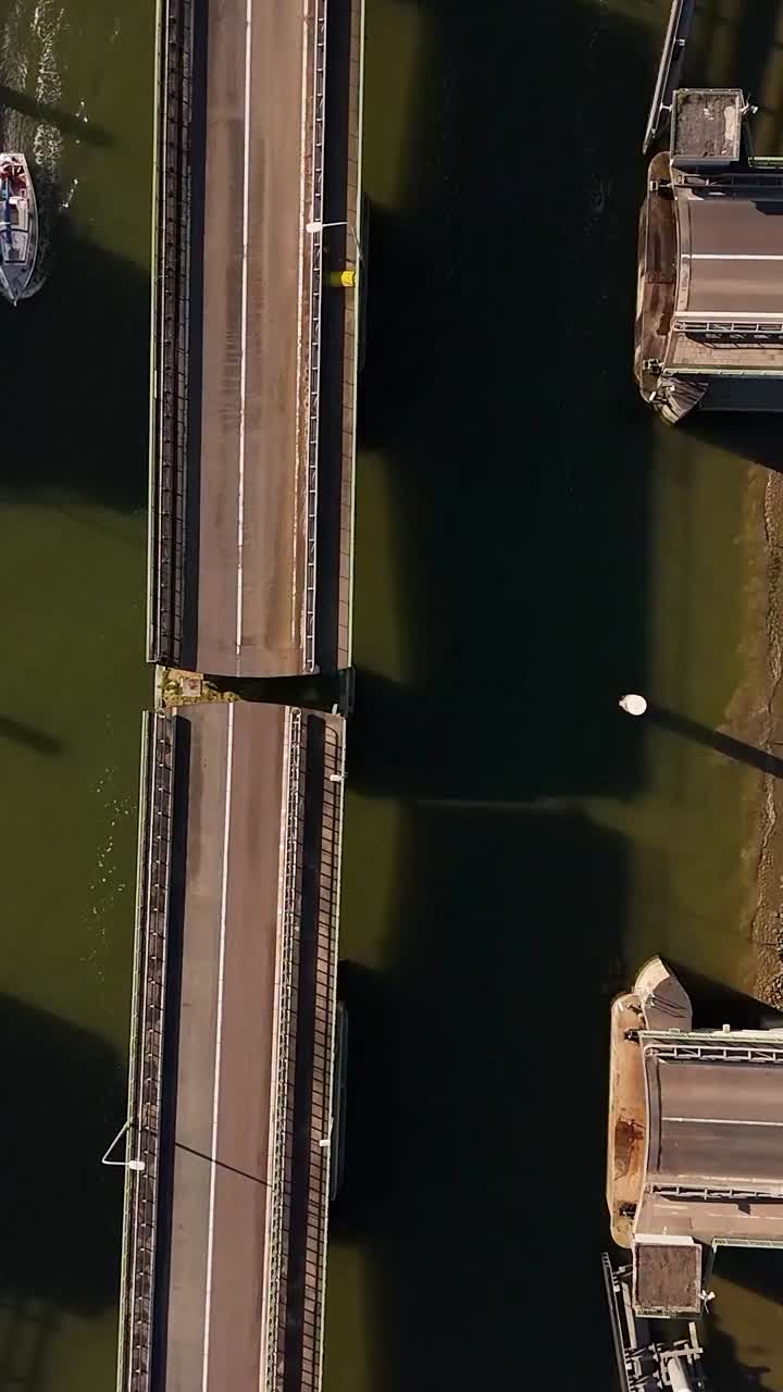 Elevated view of a drawbridge over a canal with a boat passing below