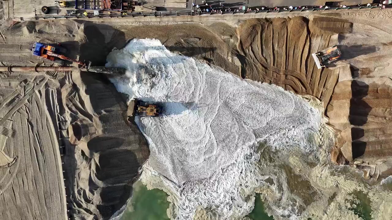 Birds eye view of a major coastal defence scheme extending the beach approximately 25 metres between King Alfred Leisure Centre and Second Avenue. Hove, East Sussex, United Kingdom.