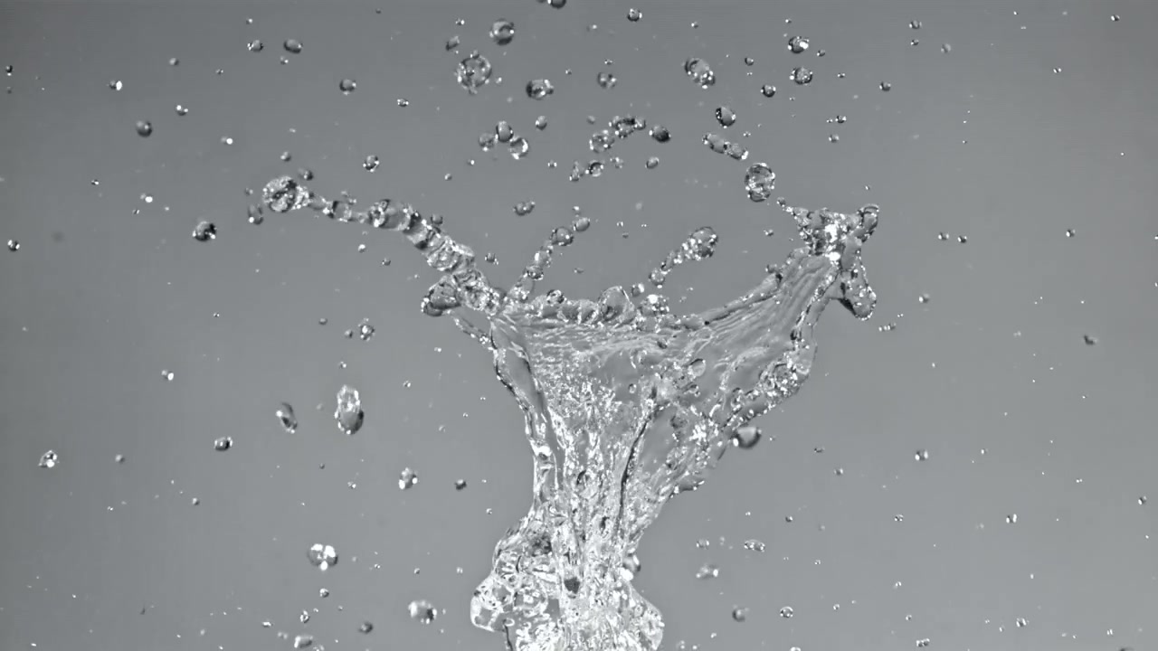 Slow Motion Water Splash and Droplets Against a Grey Background