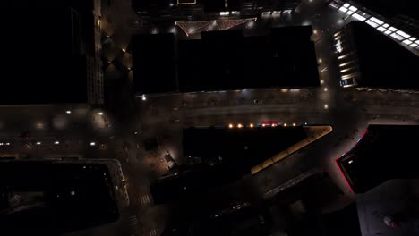 Night-scene-in-downtown-Reykjavik-city-with-buildings-and-lights,-top-down