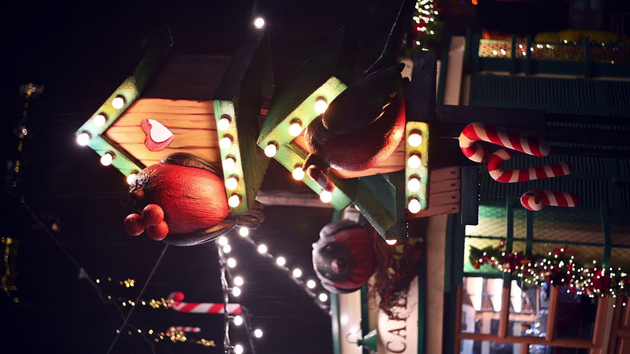 Festive decorations light up the night at a lively street market. Candy canes and glowing ornaments create a warm and cheerful atmosphere for visitors