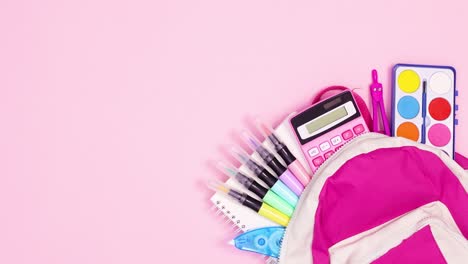 paper for text appear next to backpack with school tools. stop motion