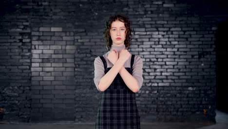 serious young environmental activist looking at the camera and showing her arms with go green" inscription"