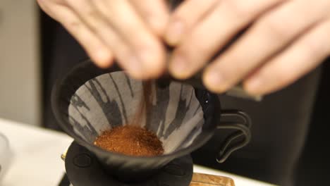 fresh roasted coffee pouring in a filter over glass jar