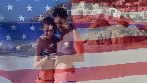 Animation-of-flag-of-usa-over-caucasian-couple-on-beach-in-summer