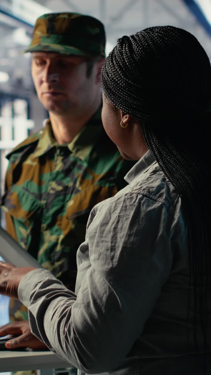 Vertical Video Team Of Military Specialists In Data Center Looking At World Map On Screen