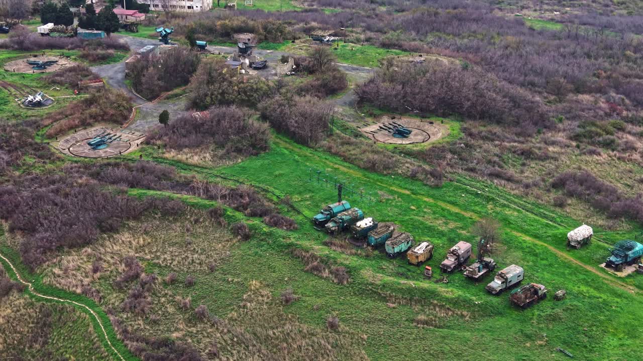 Aerial view of military convoy and artillery in green fields
