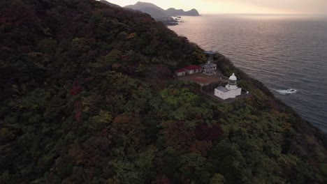 Aerial-sunset-beach-cliff-landscape-skyline-and-mountain-resorts,-Japan-Kyotango-Kyoto-Natural-environment,-travel-destination,-Japanese-sunset-discovery-shot