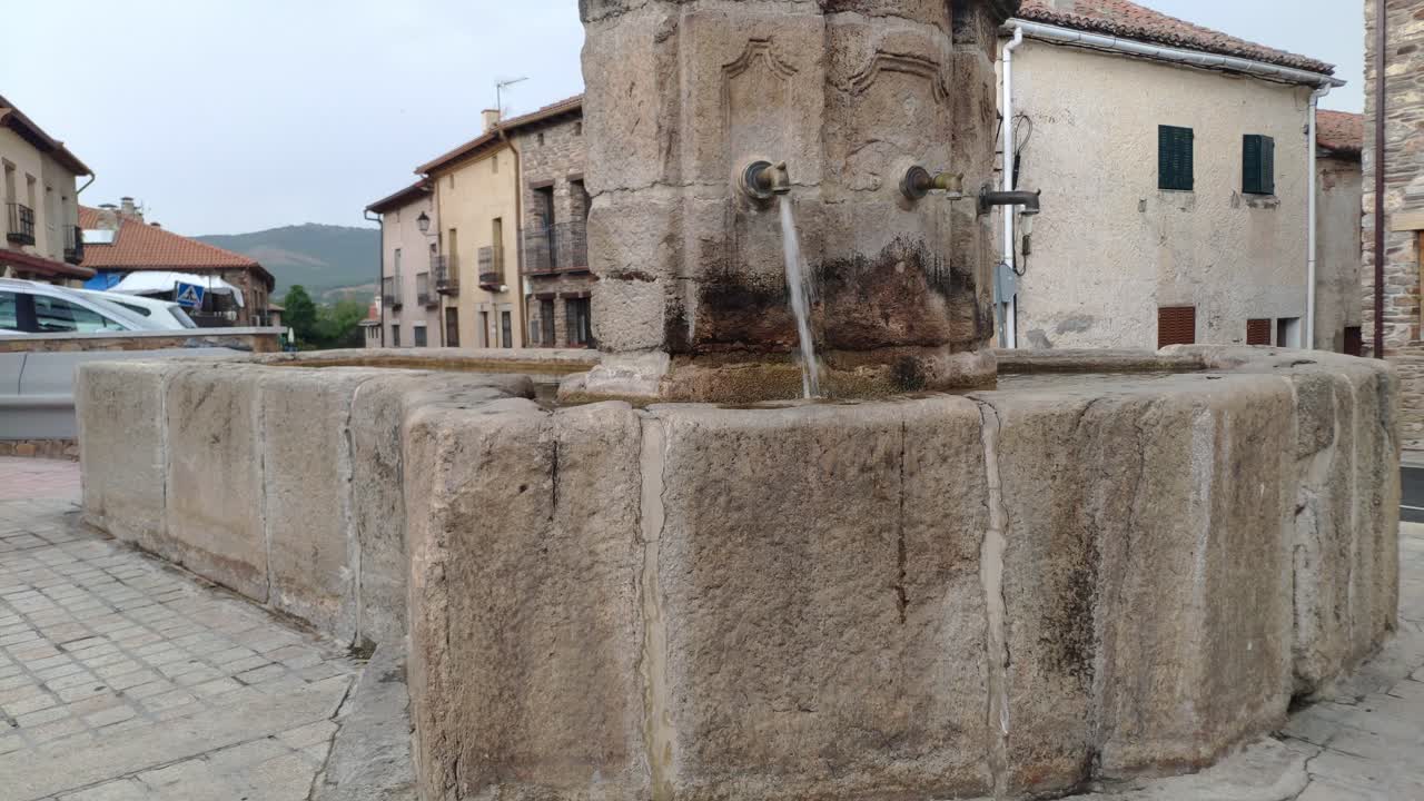 Fuente De Los Tres Caños fountain in Montejo De La Sierra, showcasing old stonework and water flow