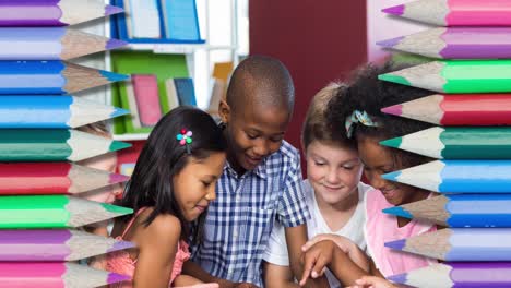 Animation-of-pencils-over-diverse-schoolchildren-using-tablet-and-smiling