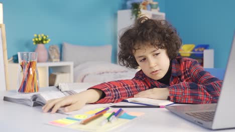 tired boy falling asleep while doing homework.