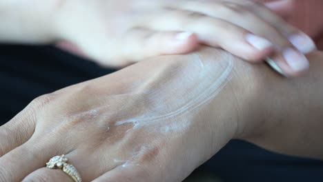 applying lotion on hands and wrist