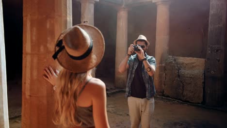 tourists couple with camera taking photos at european archaeological site