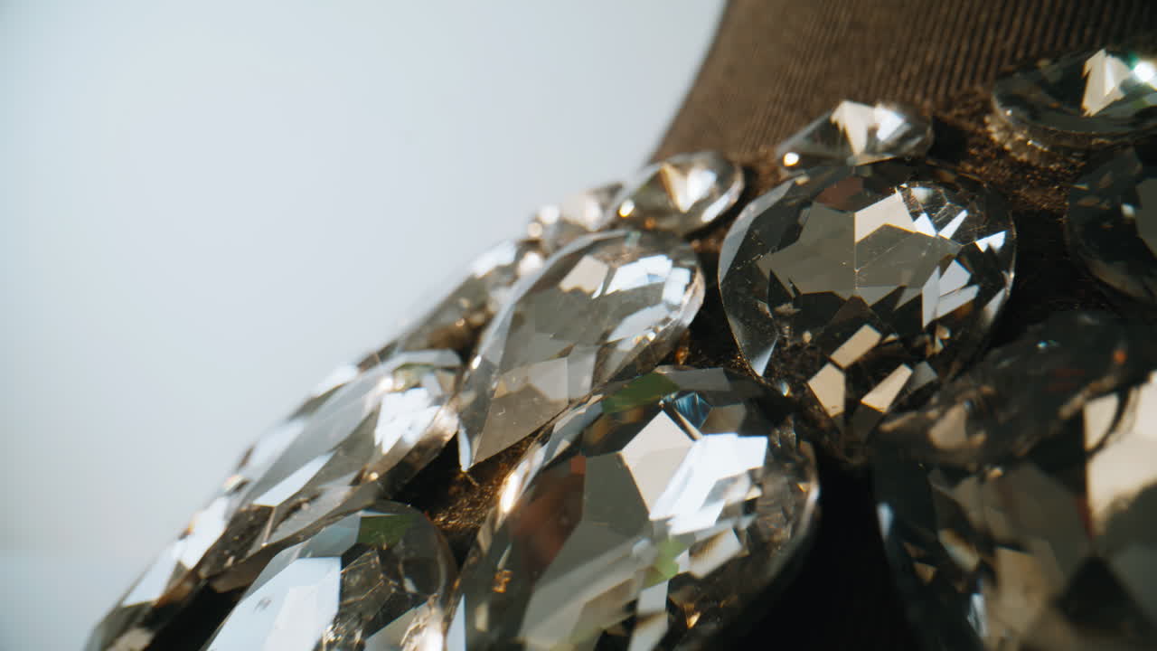 Closeup crystal necklace reflecting light inside studio. Decorative accessory