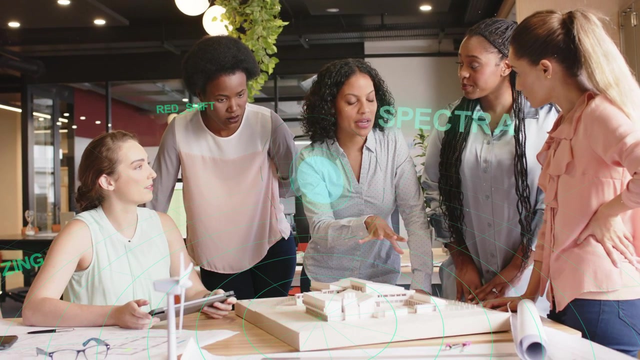 Diverse Businesswomen Discussing Architectural Model with Digital Data Overlay