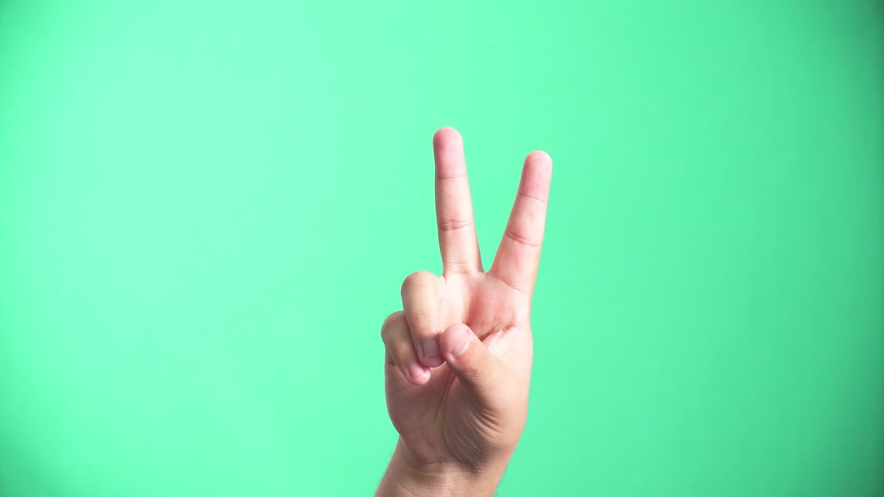 A cheerful person giving waving. Love and peace. 4k green screen