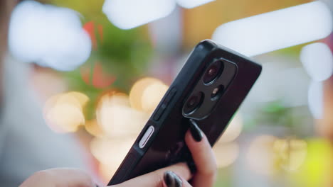 close-up of phone being operated with vibrant colorful bokeh light effect in the background, highlighting smartphone technology and modern communication in a stylish, dynamic environment