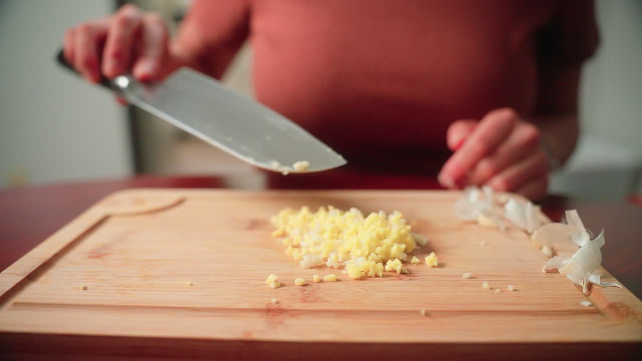 Woman mixing minced garlic and ginger together