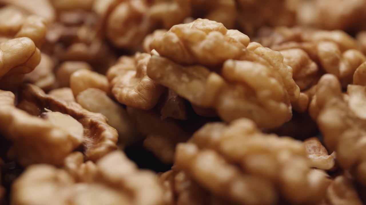 Smooth Camera Movement Over a Handful Walnuts.